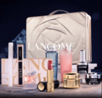 Lancome gift set display featuring various luxury skincare and makeup products, including lipstick, mascara, toners, and creams, with a rose-embossed cosmetic case in the background.