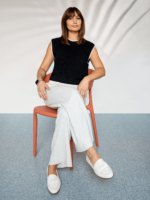 Picture of Chloé Lorini sitting in an orange chair smiling.