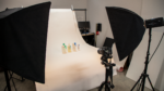 Photo studio setup with lights, camera, and CeraVe products on a white backdrop.